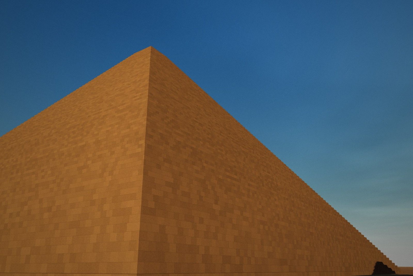 Low view along the stepped core masonry of the Great Pyramid rising into the sky.
